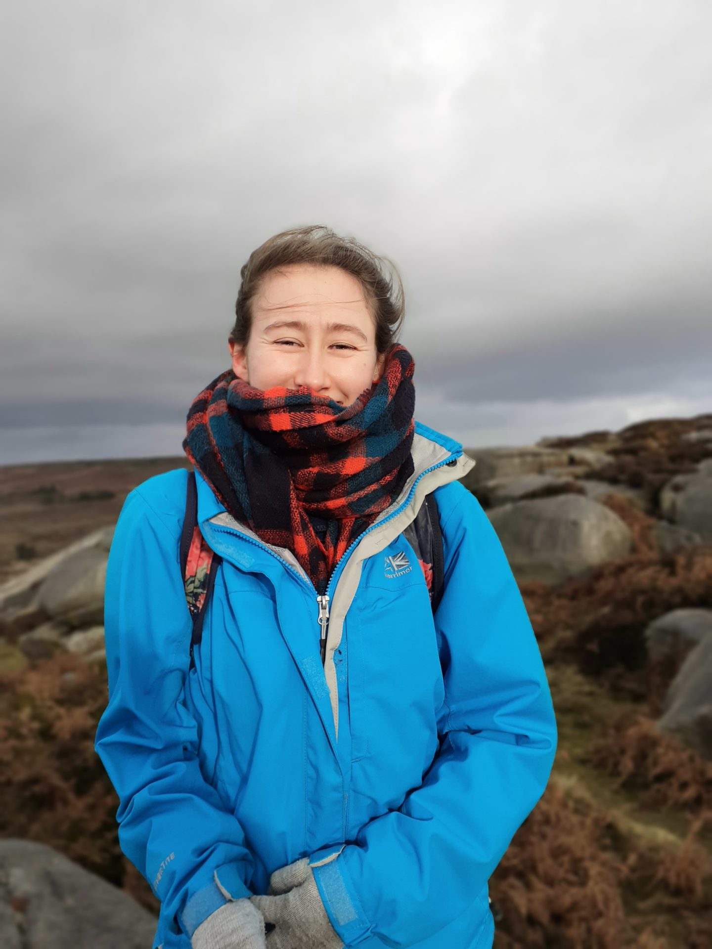 Photo of Rosalind Martin outdoors wearing a blue coat and a scarf