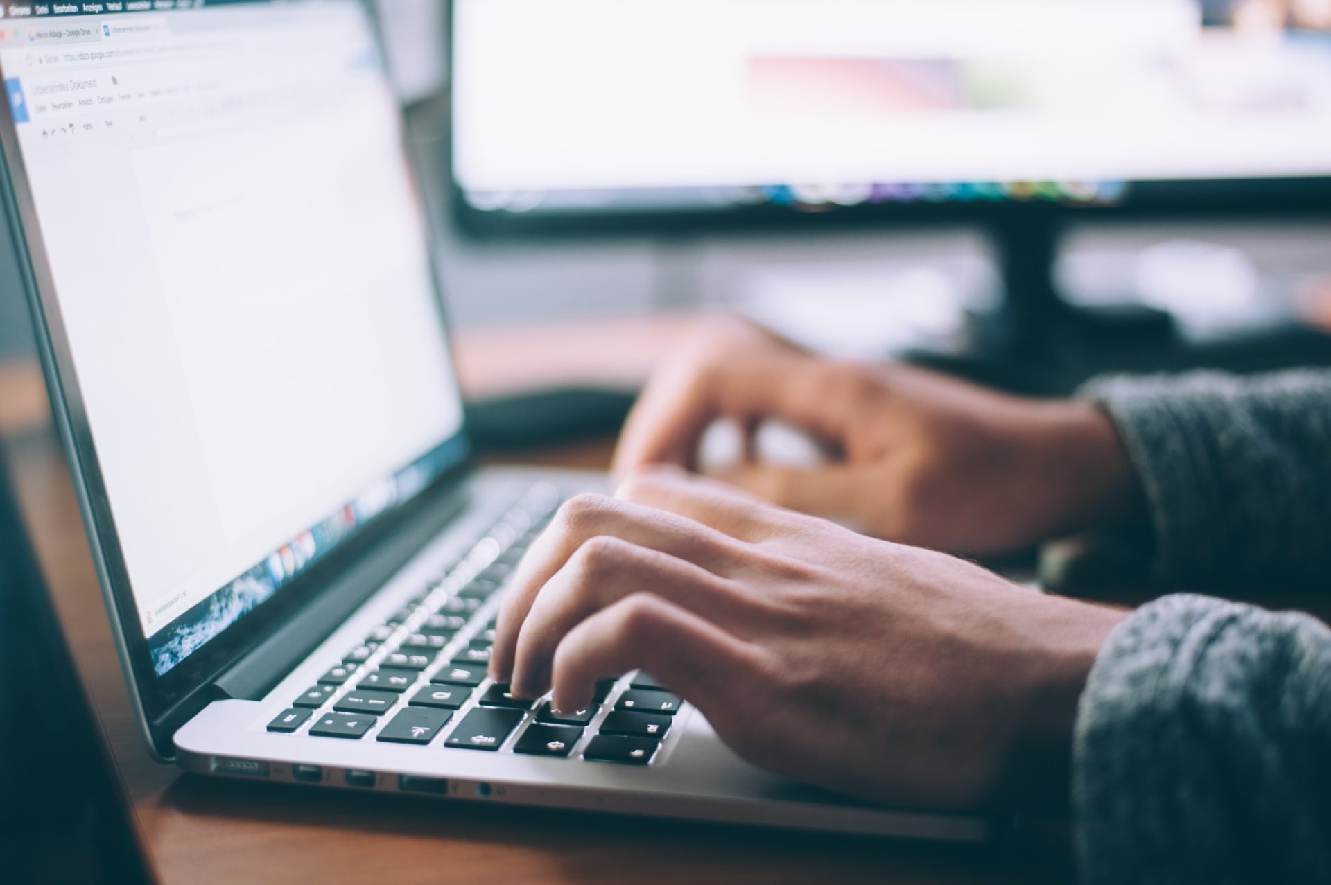 Someone's hands on laptop keyboard