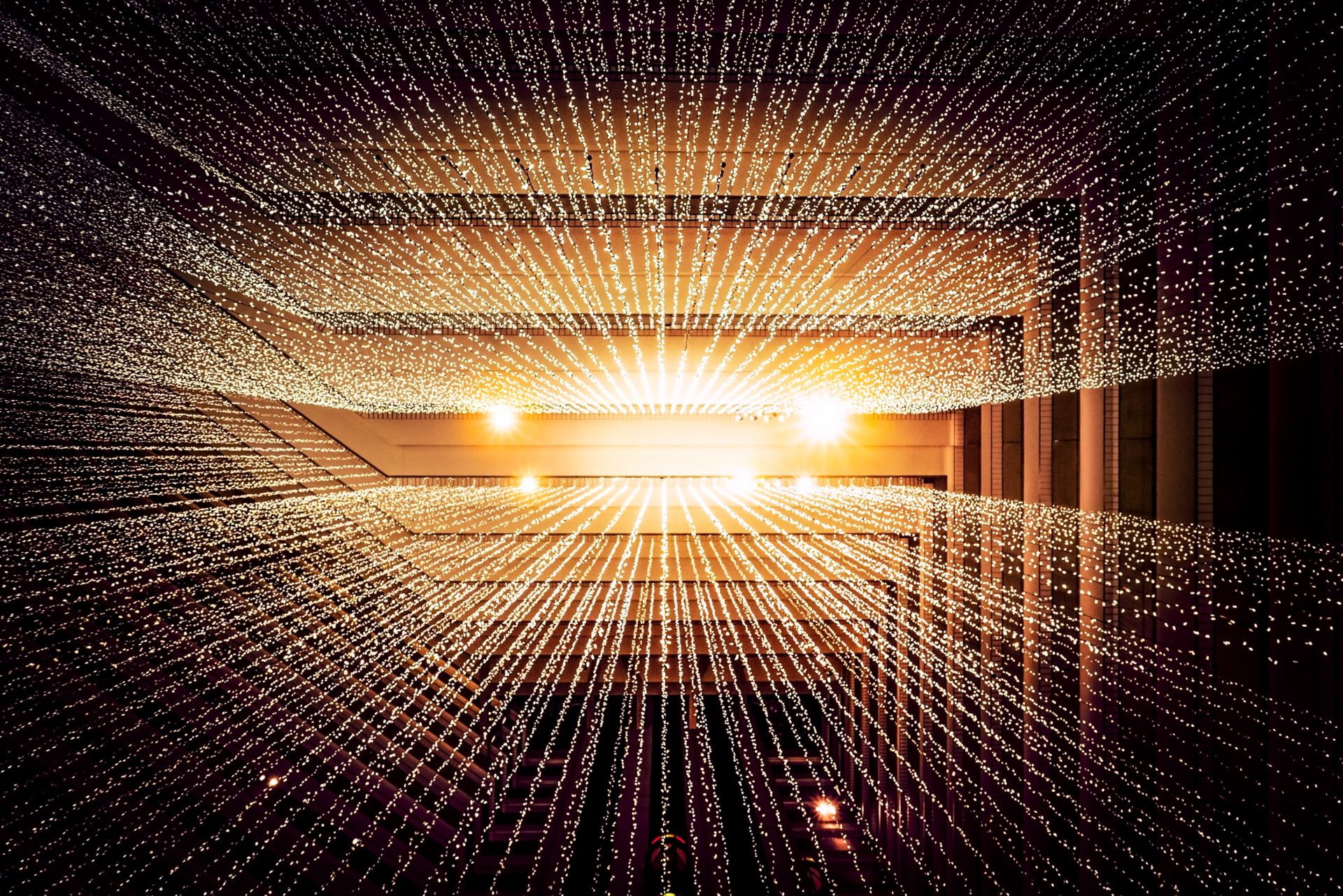 Data shown in gold converging into a point of light on the horizon like a sunset