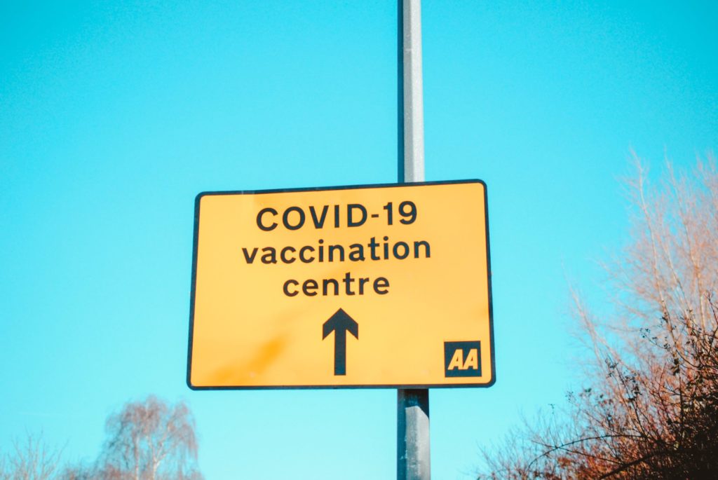 Yellow COVID-19 vaccination centre road sign