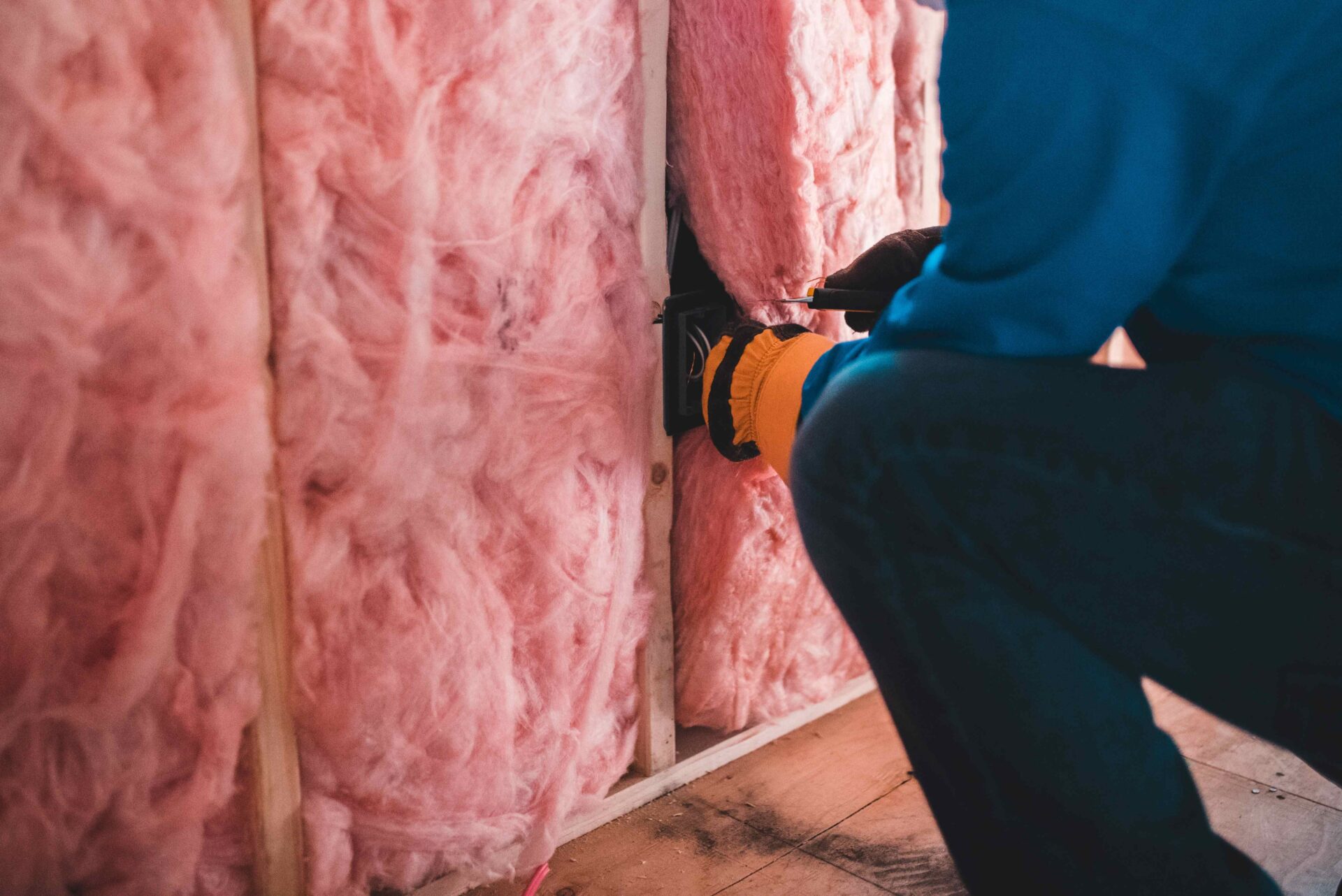 Person wearing gloves installing insulation - in reference to CDRC making Priority Places for Insulation Index data available for researchers